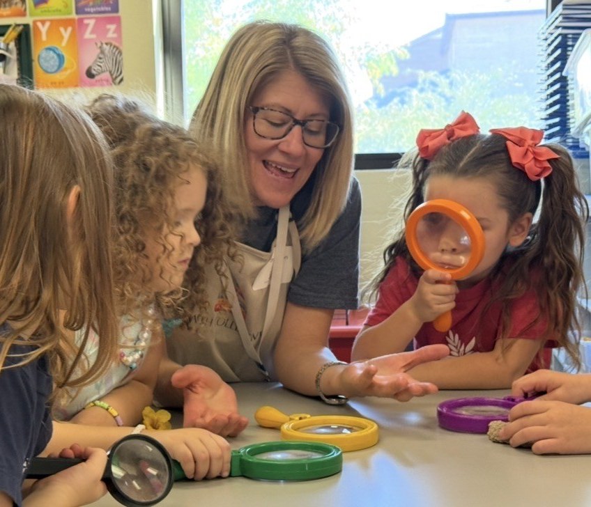 PATH Collective students exploring with magnifying glasses