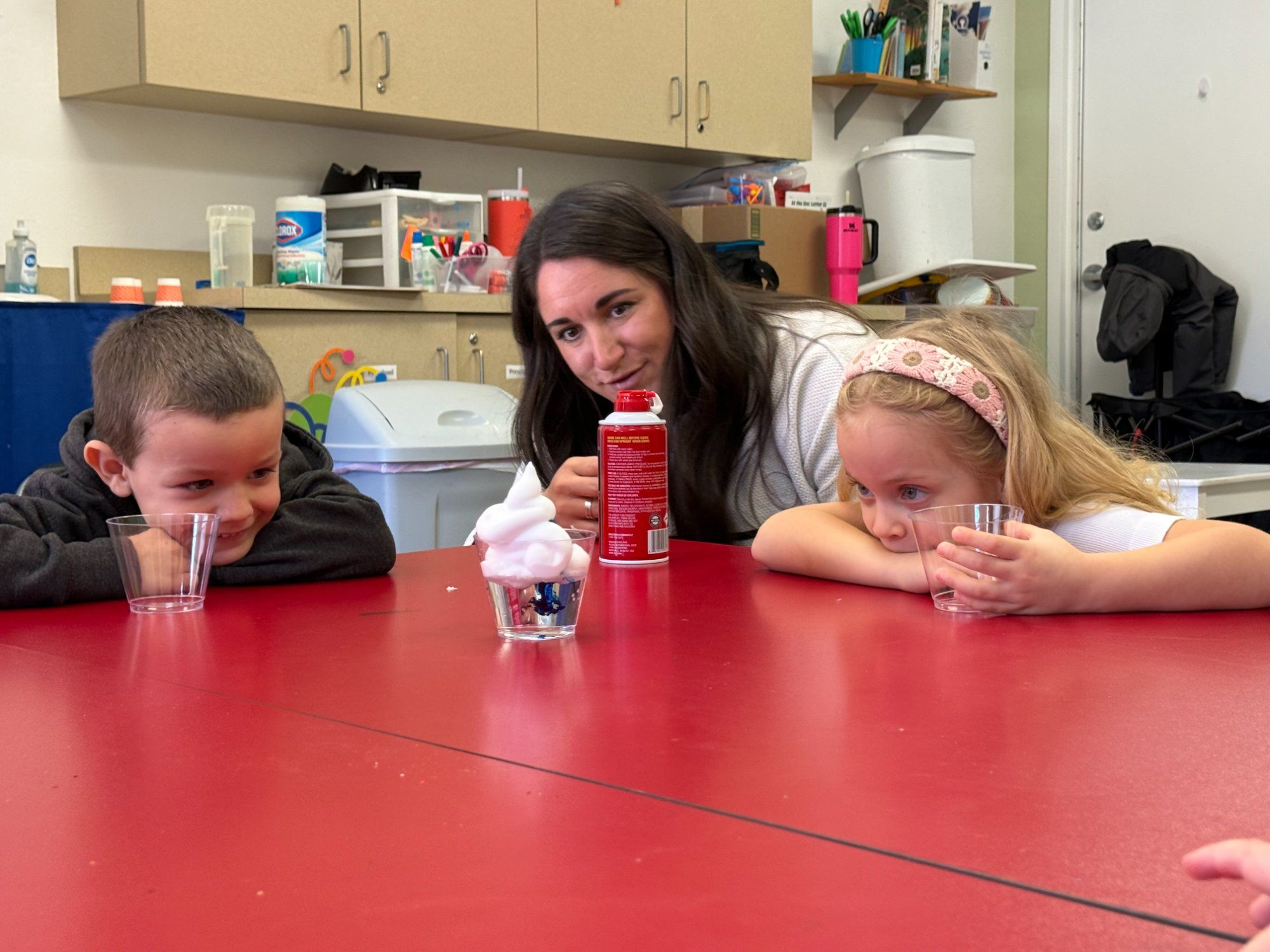 Teacher doing science experiment with young students at PATH