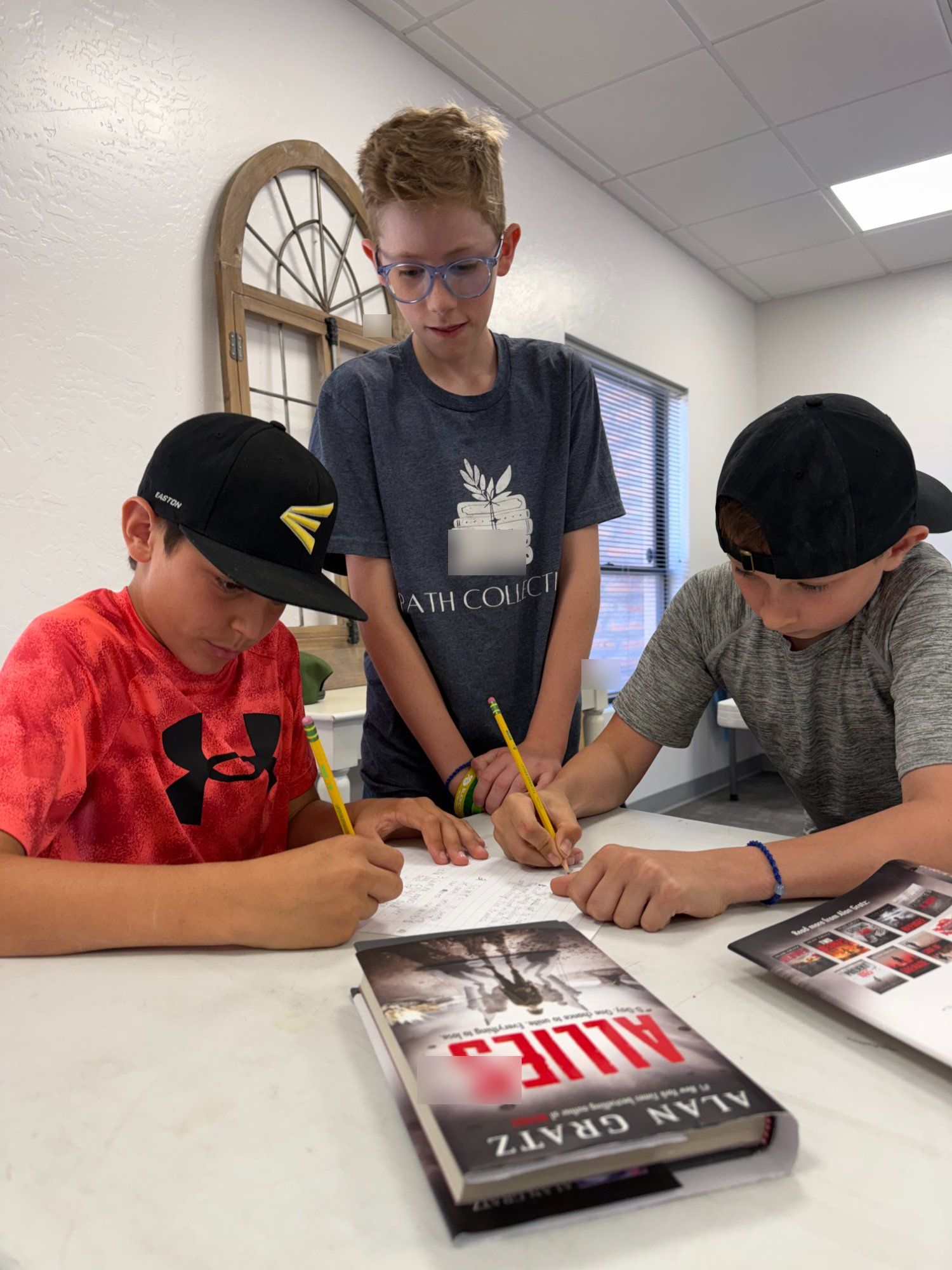 Students collaborating on writing at PATH Collective
