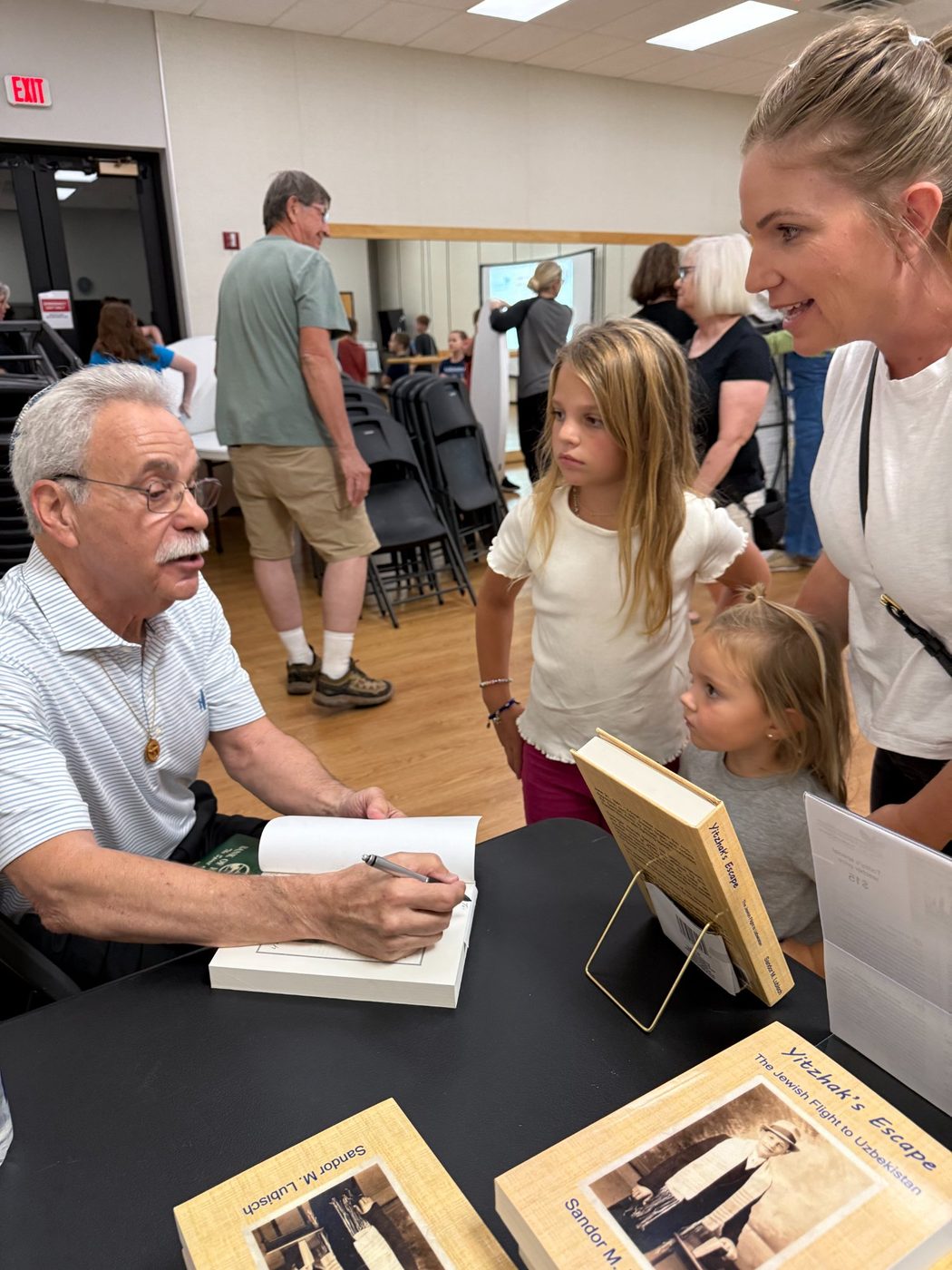 Sandor Lubisch signing books for PATH families