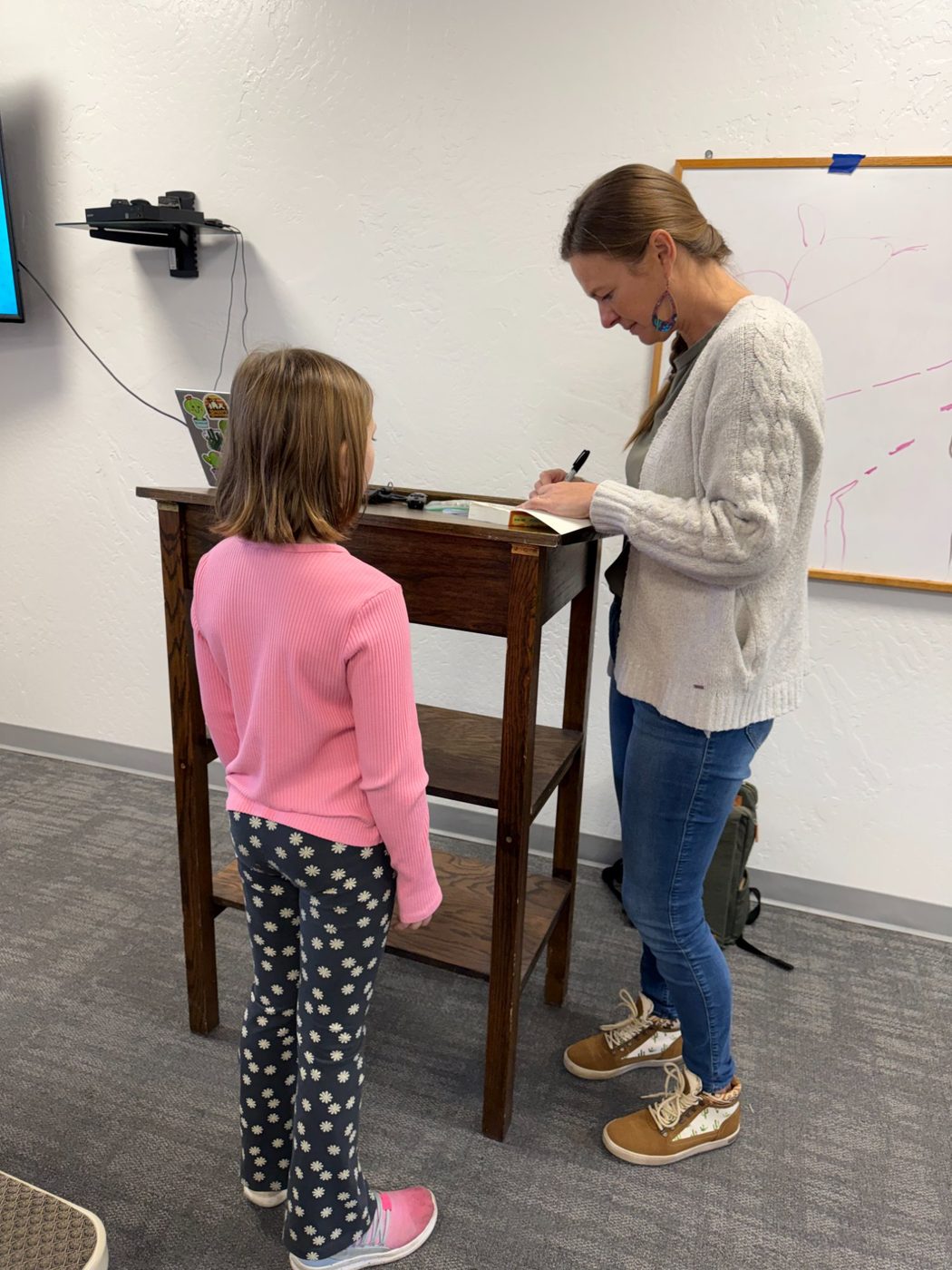 Dusti Bowling signing a book for a PATH student
