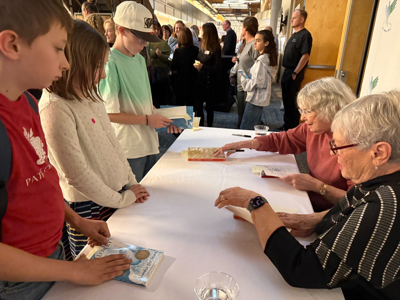 PATH students getting their books signed by Lois Lowry
